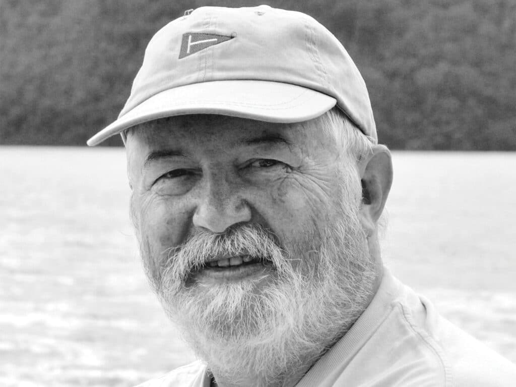 A black and white image of Dr. Julian Pepperell wearing a fishing cap.