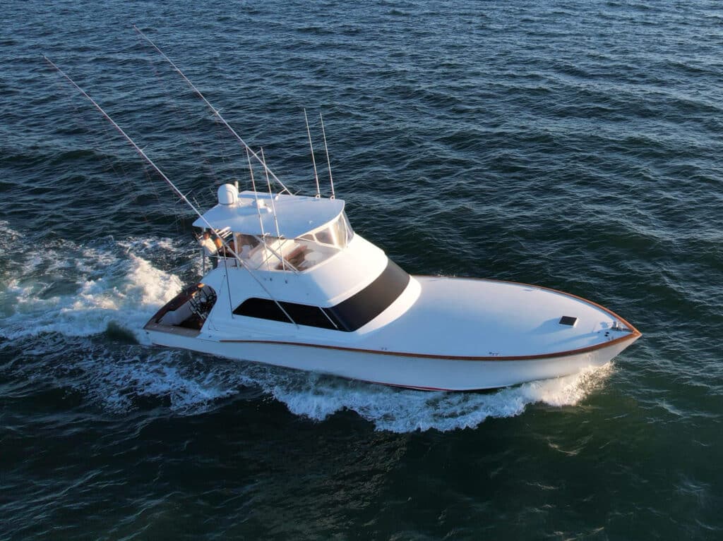 A sport-fishing boat cruises across the ocean.