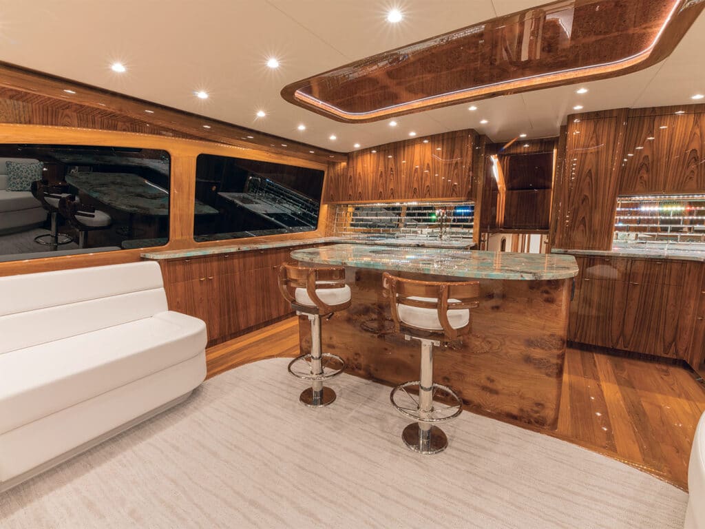 The interior salon with a view of the galley, showcasing clean lines and hardwood finishes.