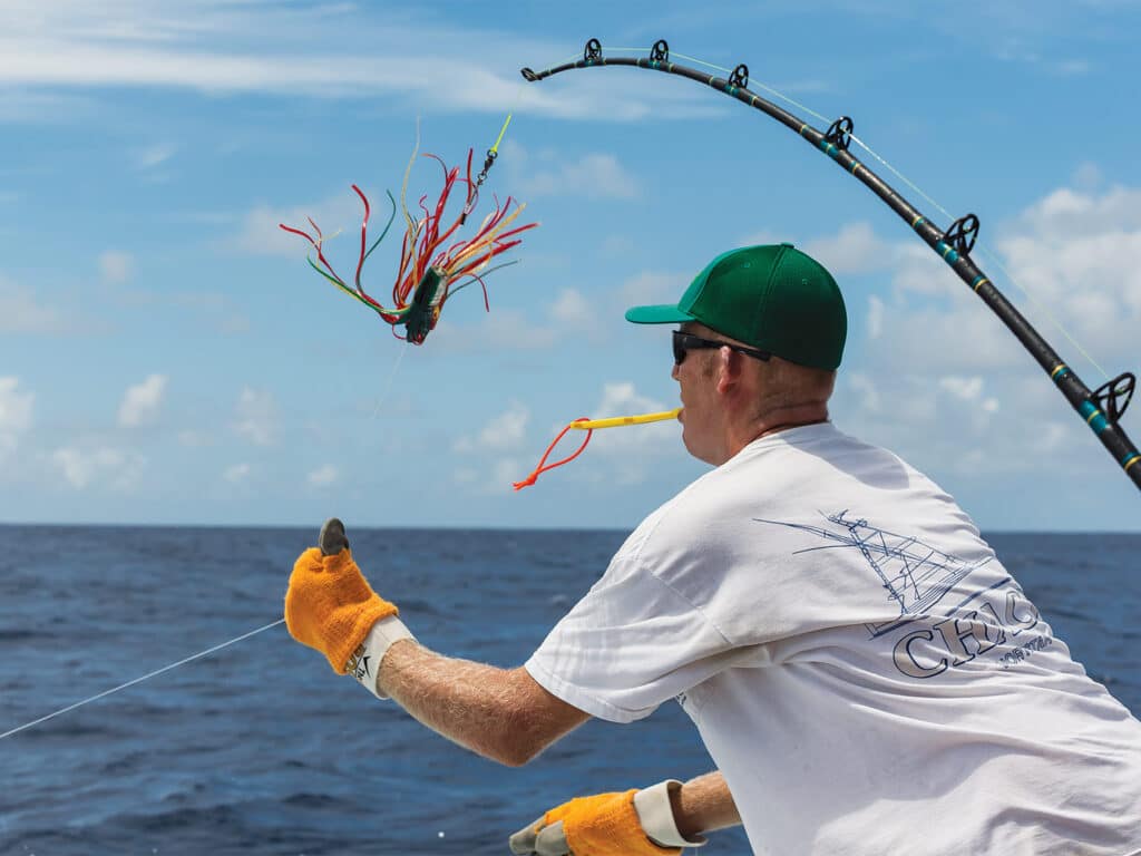 A sport-fishing angler working tackle during a fishing excursion.