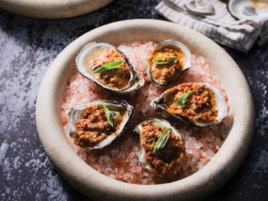 A plate of oysters over ice.