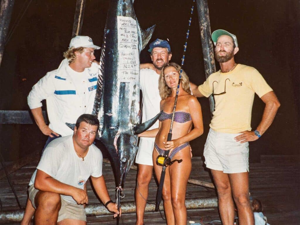 An old image showing Capt. Skip Smith and crew standing next to a record marlin.