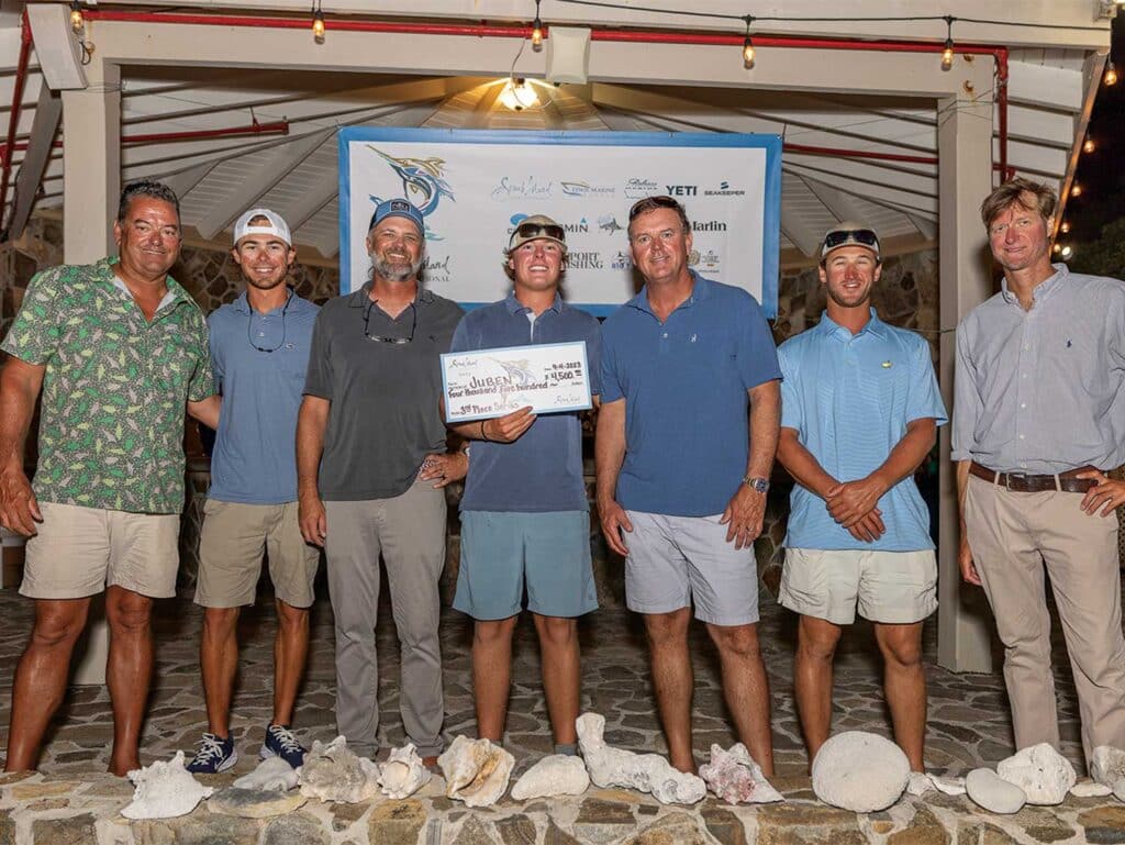 A sport-fishing team standing at an awards ceremony.