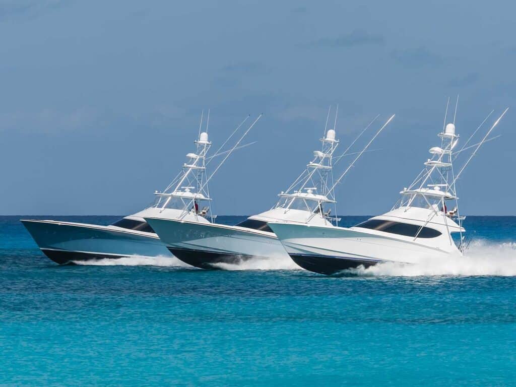 Three sport-fishing boats cruising across the open waters.