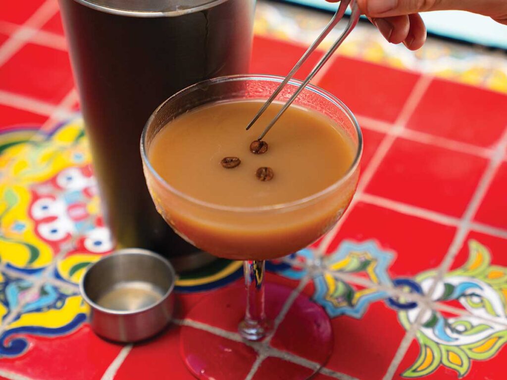 Tito's Espresso Martini served in a martini glass and garnished with three coffee beans.