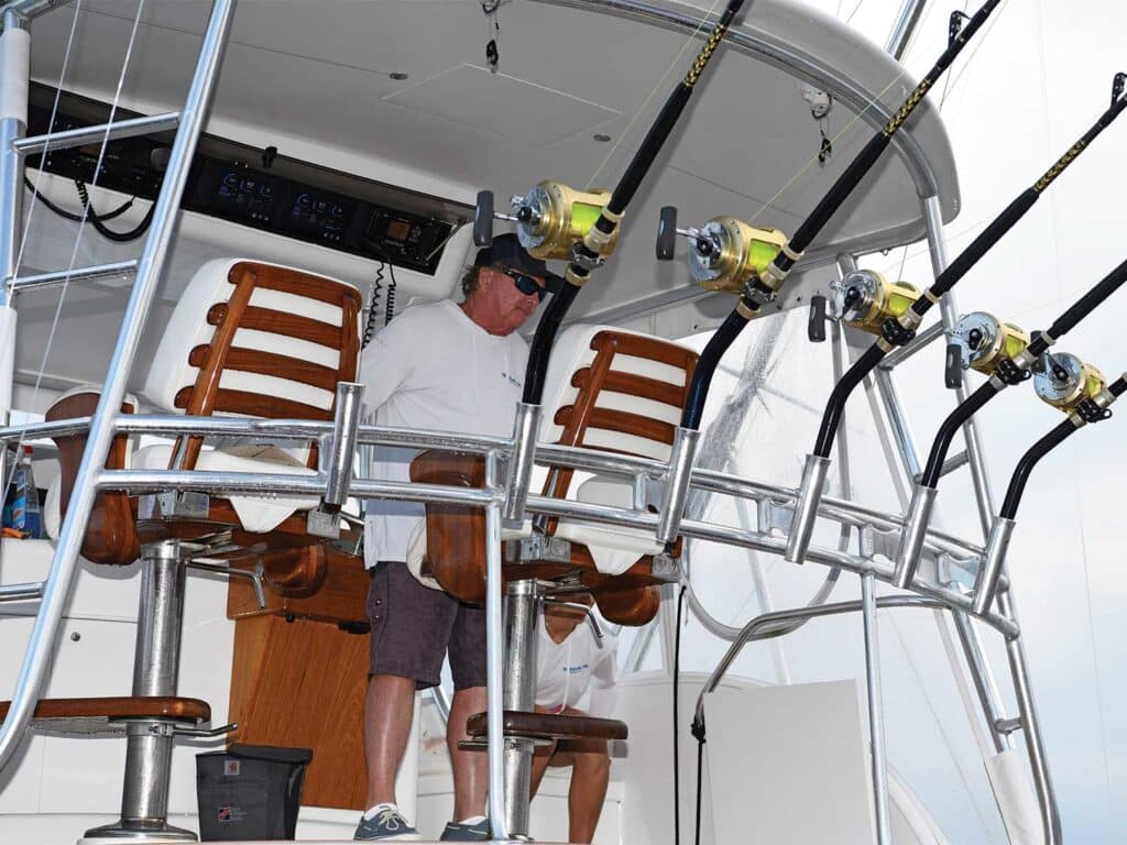 A sport-fishing captain overlooking fishing tackle.