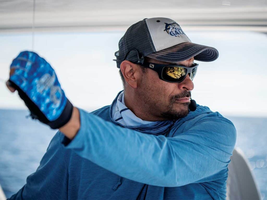 Capt. Tony Carrizosa at the helm, overseeing a spread during a fishing expedition.