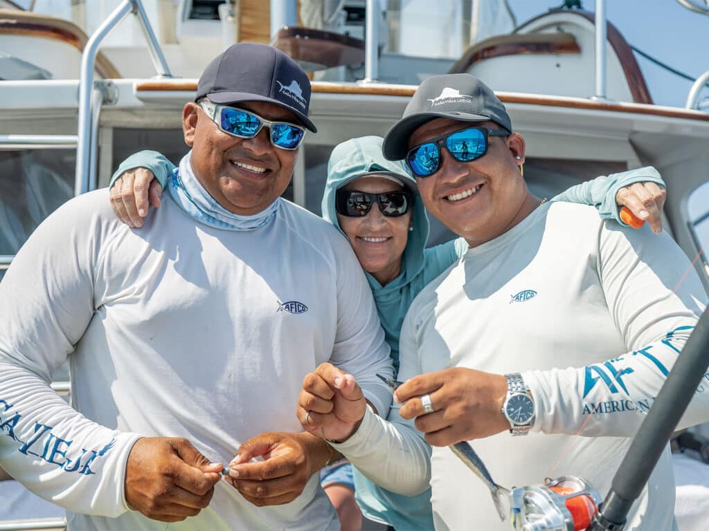 Capt. Jen Copeland and two crewmates posing and smiling for the camera.