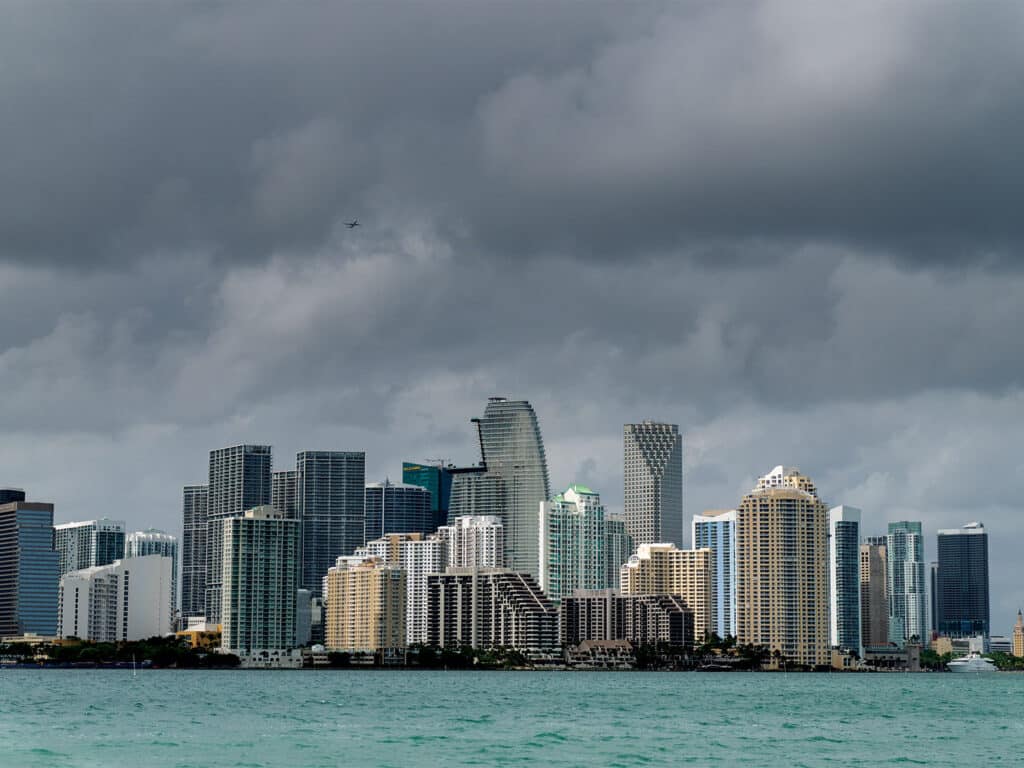 A view of the downtown Miami skyline amongst darkening clouds.