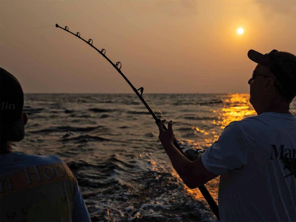 A sport-fishing angler fishing during the susnset of Guatemalan.