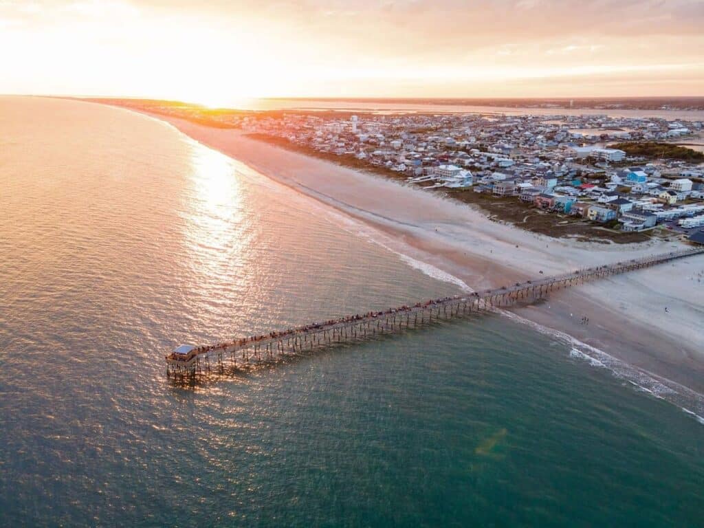 Aerial view of the Oceanana Fishing Pier at Atlantic Beach during susnset.