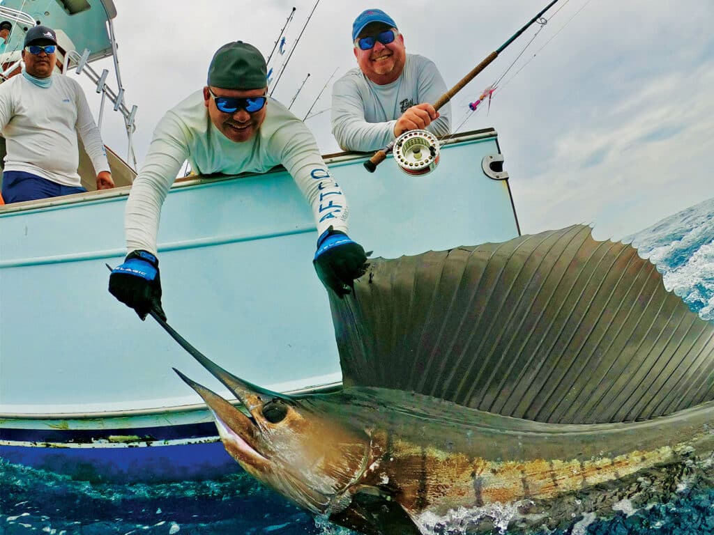 Phillip Kile pulls a large billfish boatside.