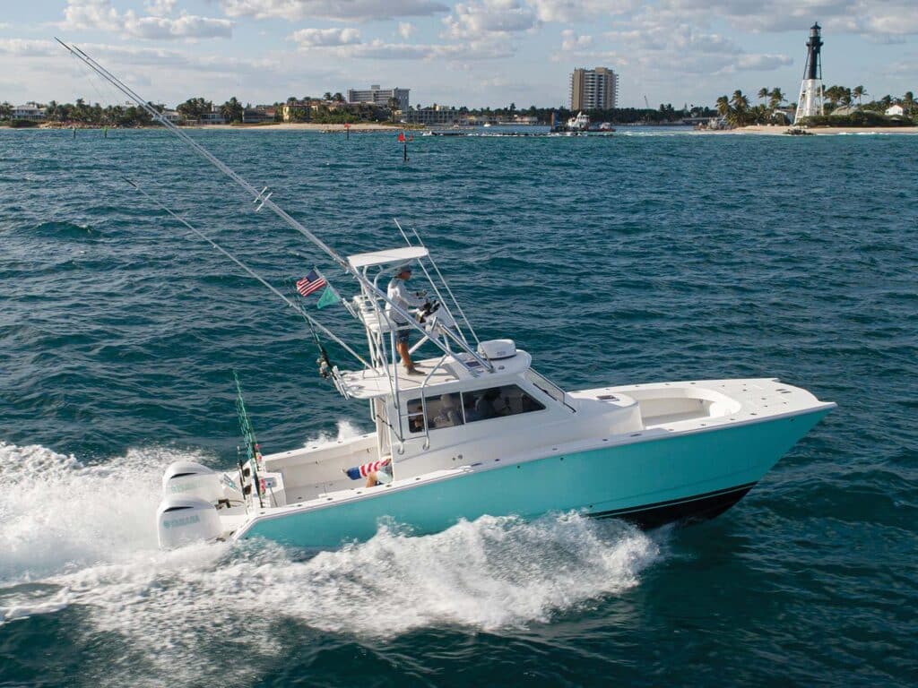 A sport-fishing catamaran cruising across the open water.