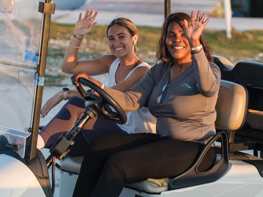 Kevie Thomas driving a resort guest around on an small UTV.