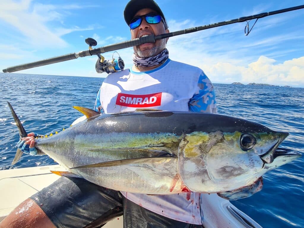 Angler holding a yellowfin tuna.