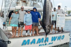 A sport-fishing team at the weigh-in of a marlin at the Sea Horse Anglers Club Tournament.