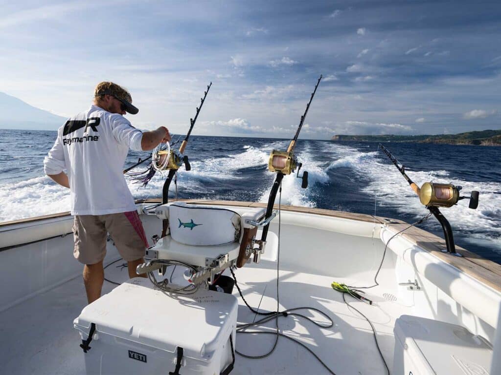 A crewmate attends the fishing reels in the cockpit of Double Header.