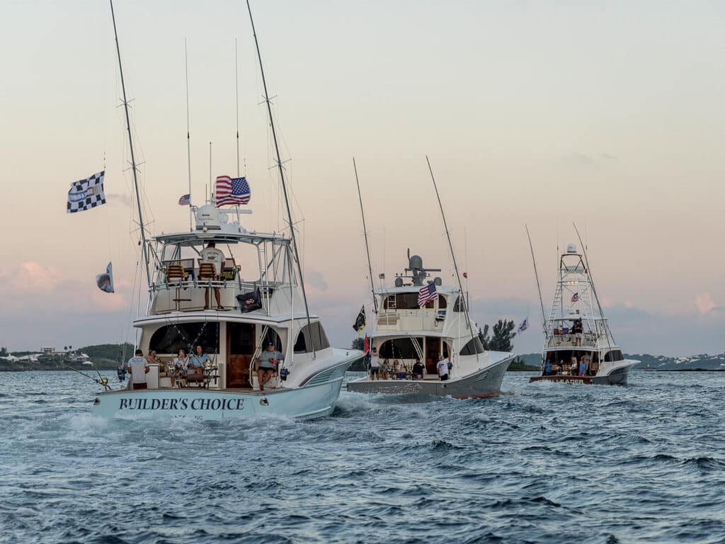 Three sport-fishing boats cruising on the open water.