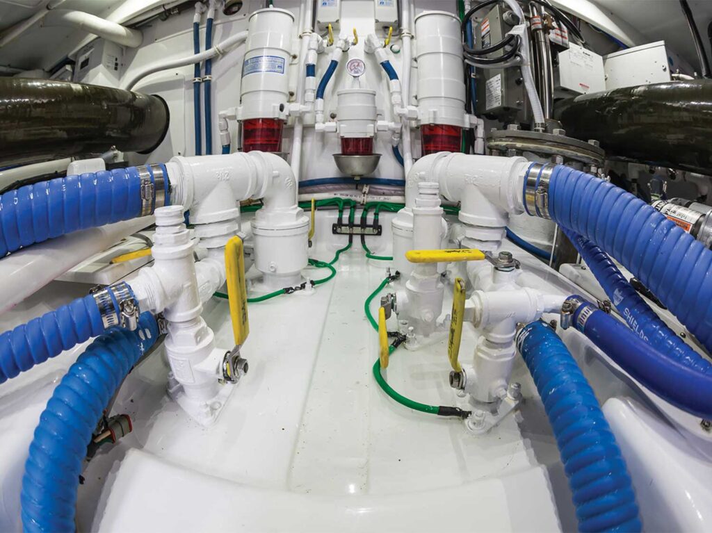 Close up of hoses and clamps in a boat's engine room.