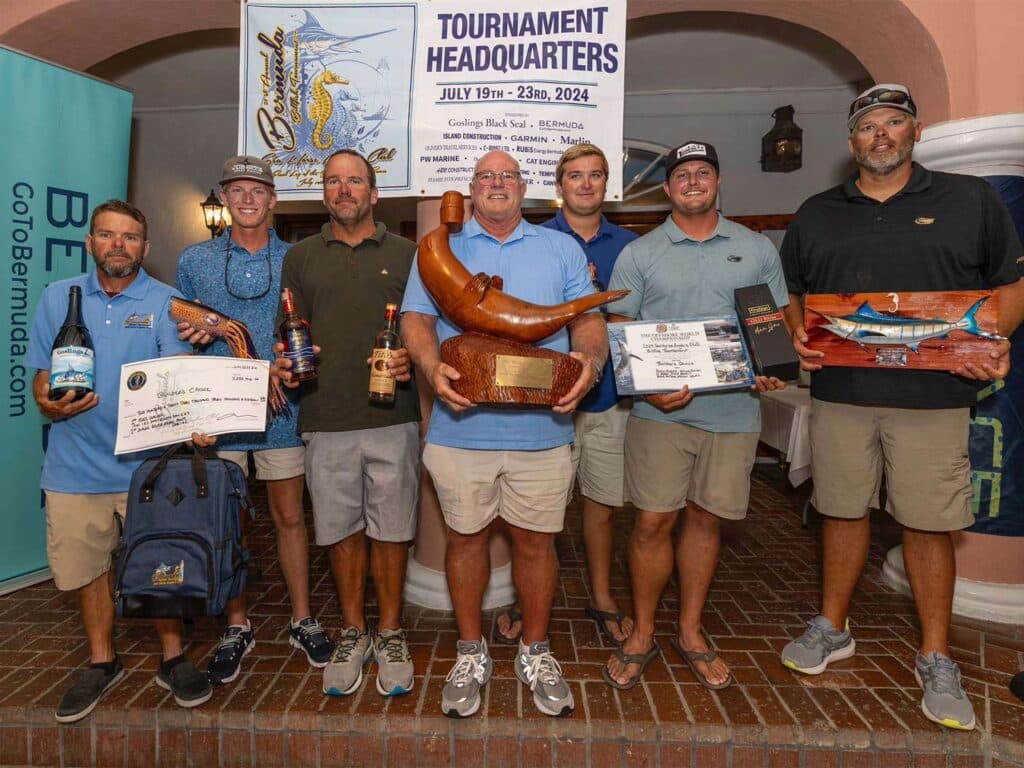 a group of men holding trophies and awards
