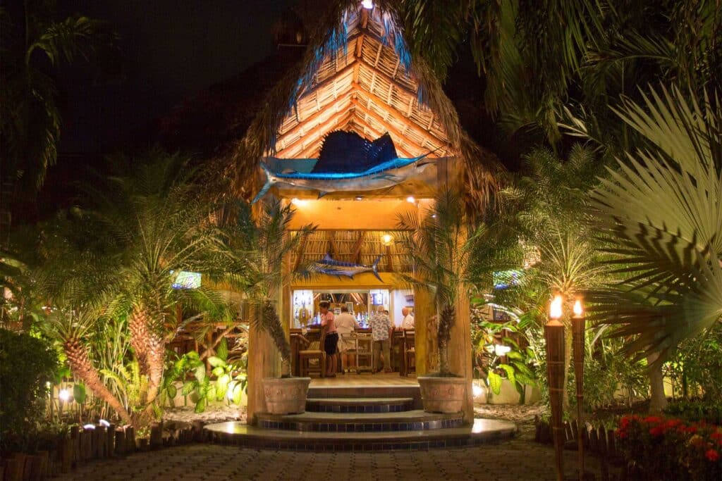 Outdoor entryway of Casa Vieja Lodge lit up at night.