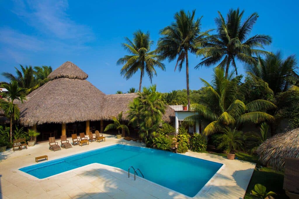 The outside pool of Casa Vieja Lodge surrounded by lush greenery.