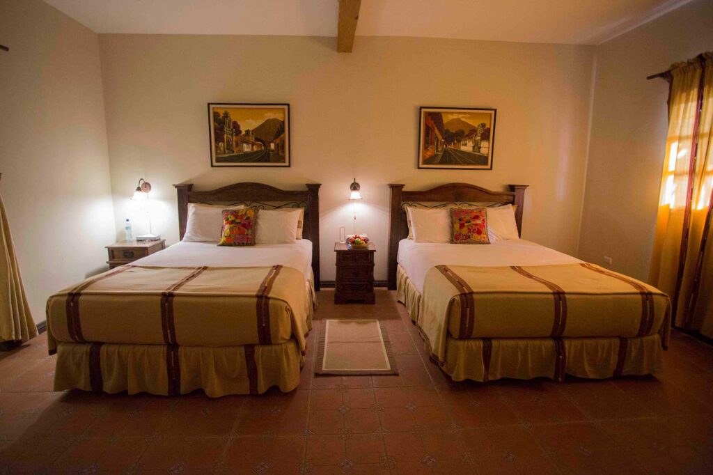 Two beds side-by-side in the room accommodations at Casa Vieja Lodge.