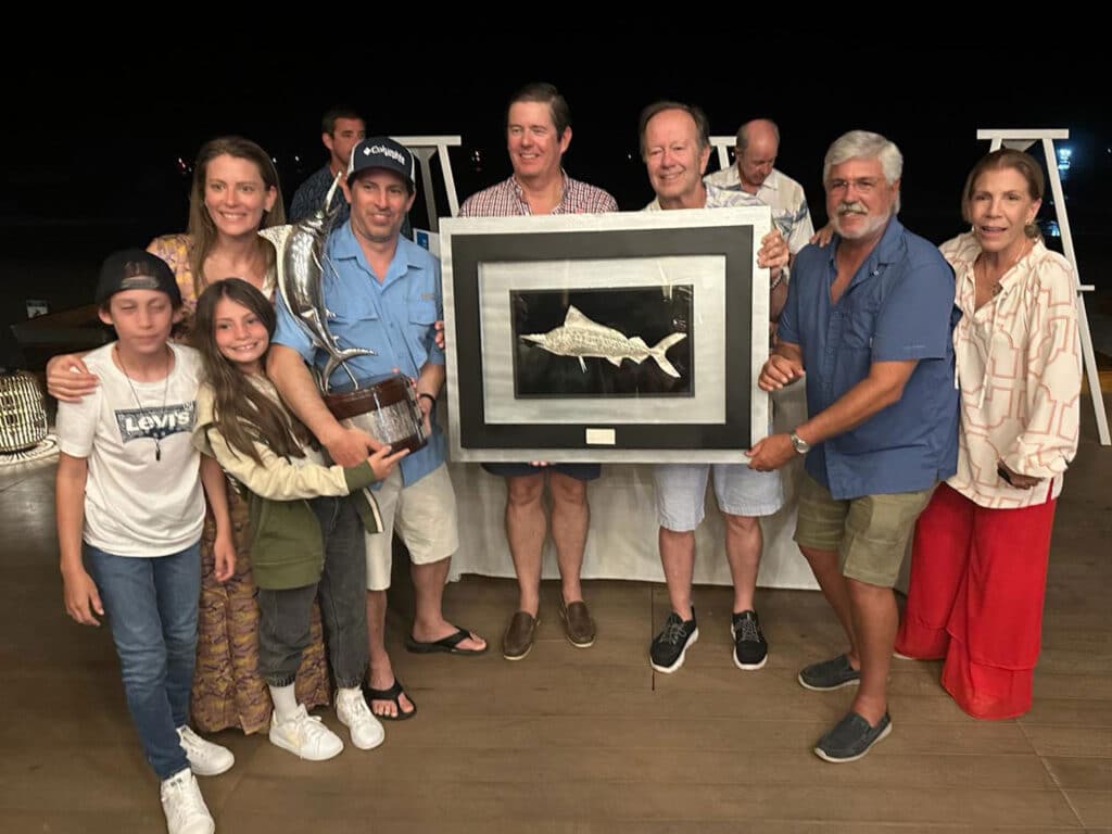 A group of anglers standing at an awards ceremony.
