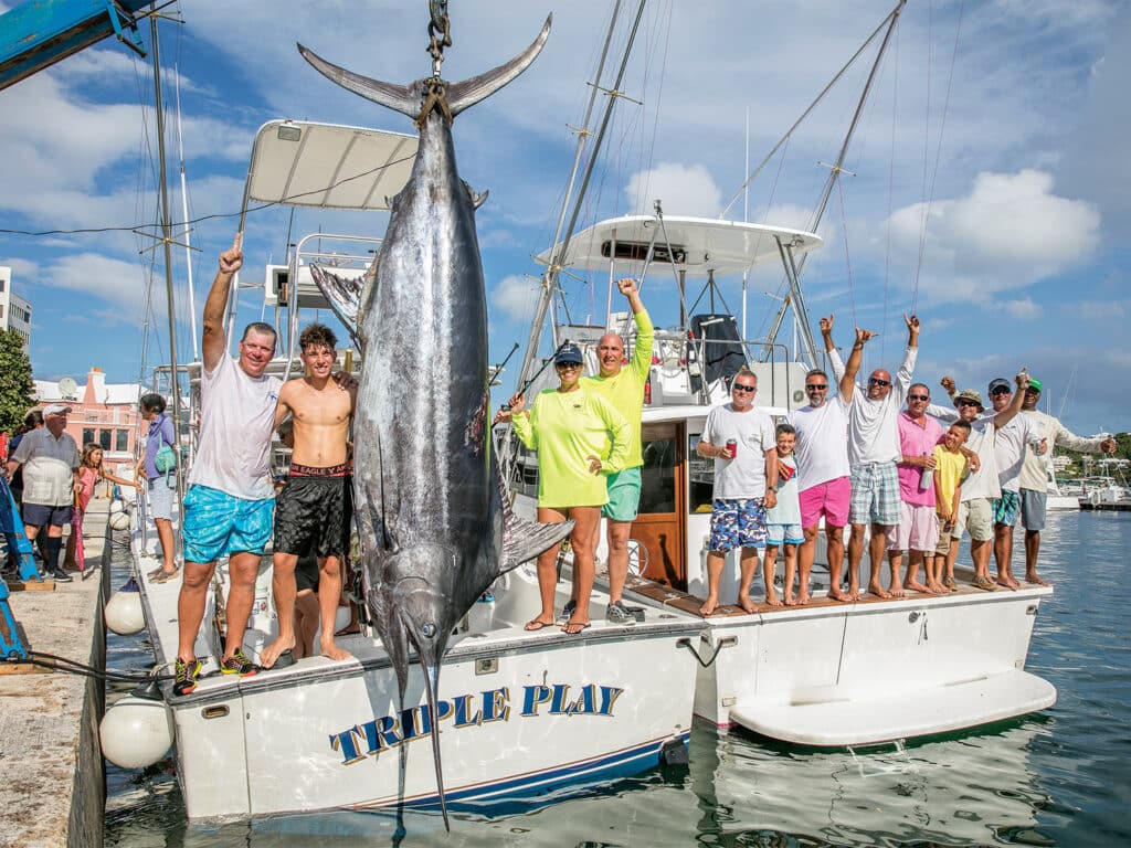 A group of anglers standing in the cockpits of a sport-fishing boat at the Bermuda Triple Crown.