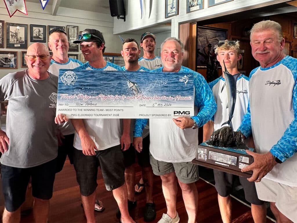 A group of anglers at an awards ceremony holding a an oversized check.