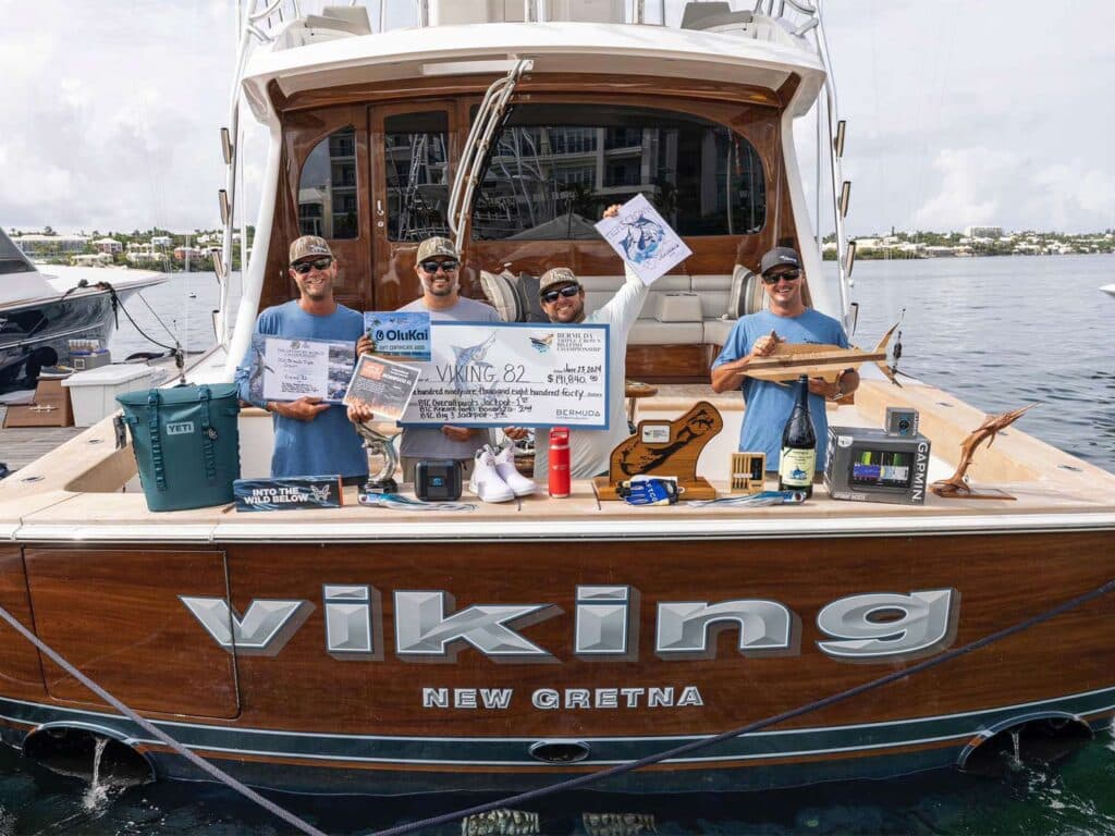 a group of men holding signs on a boat