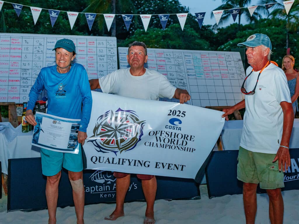 Three anglers celebrating a win and holding up an Offshore World Championship invitation.