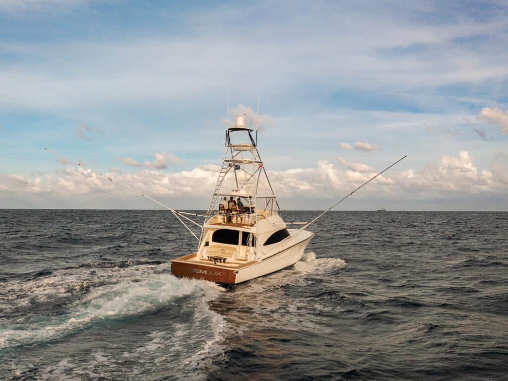 A sport-fishing boat cruises across the water.