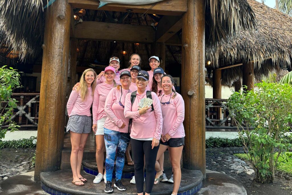 A group of women stand and pose outside of the Casa Vieja Lodge resort.