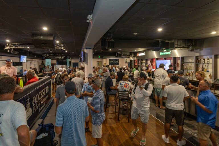 Overhead view of anglers and captains walking around a room during Tournament kickoff.