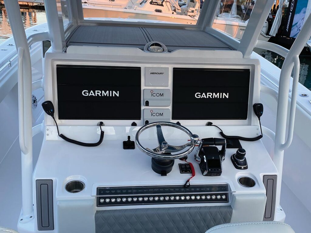 The helm of the Invincible 43 Open showing two electronic displays with the Garmin logo