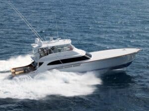 carbon fiber sailboat hull A sport-fishing boat cruises across the water leaving waves in its wake.