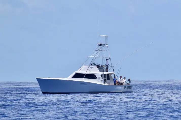 View of a sport-fishing boat cruising on the water.