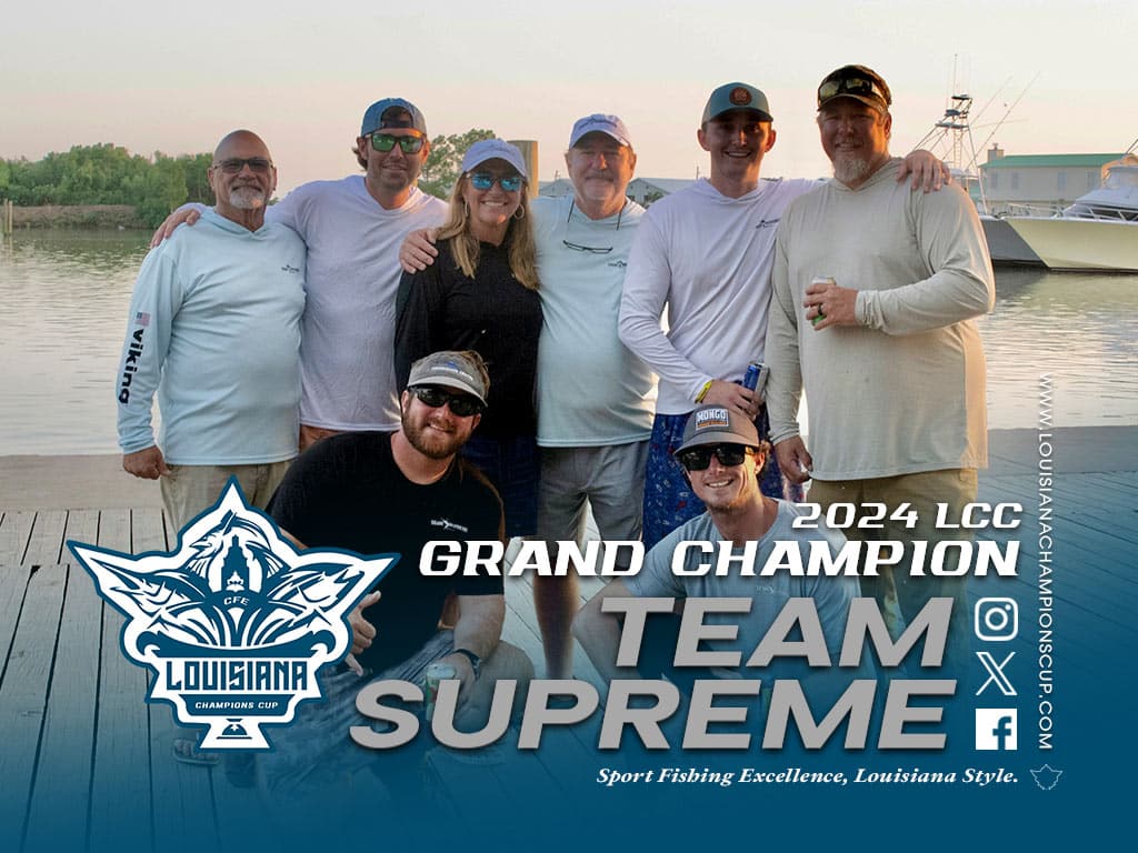 A sport-fishing team standing in celebration.