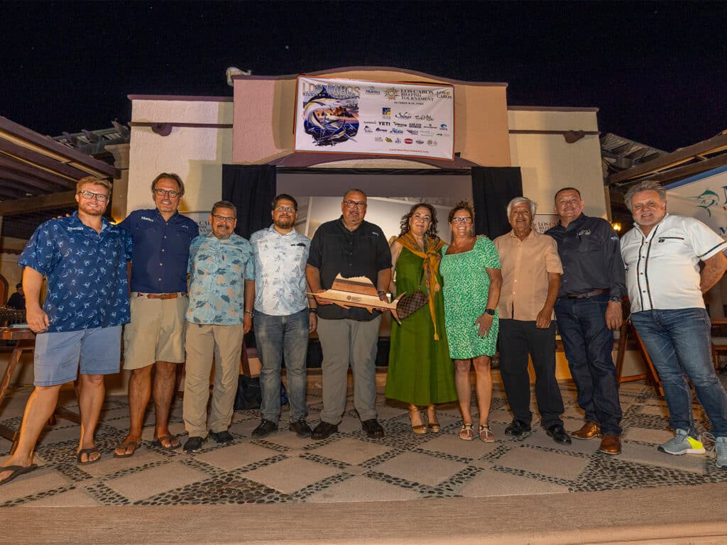 A group of Marlin staff and members of the Cabo San Lucas sport-fishing and tourism groups standing at the awards ceremony of the 2024 Los Cabos Billfish Tournament