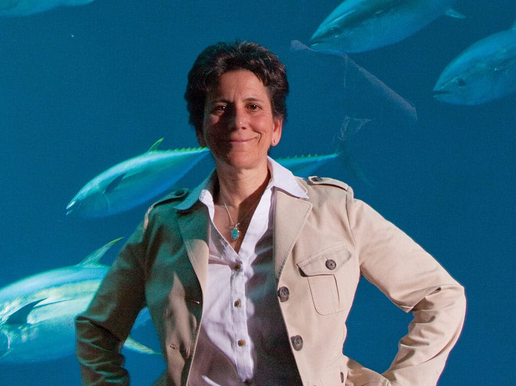 Portrait of Barbara Block standing in front of an aquarium.