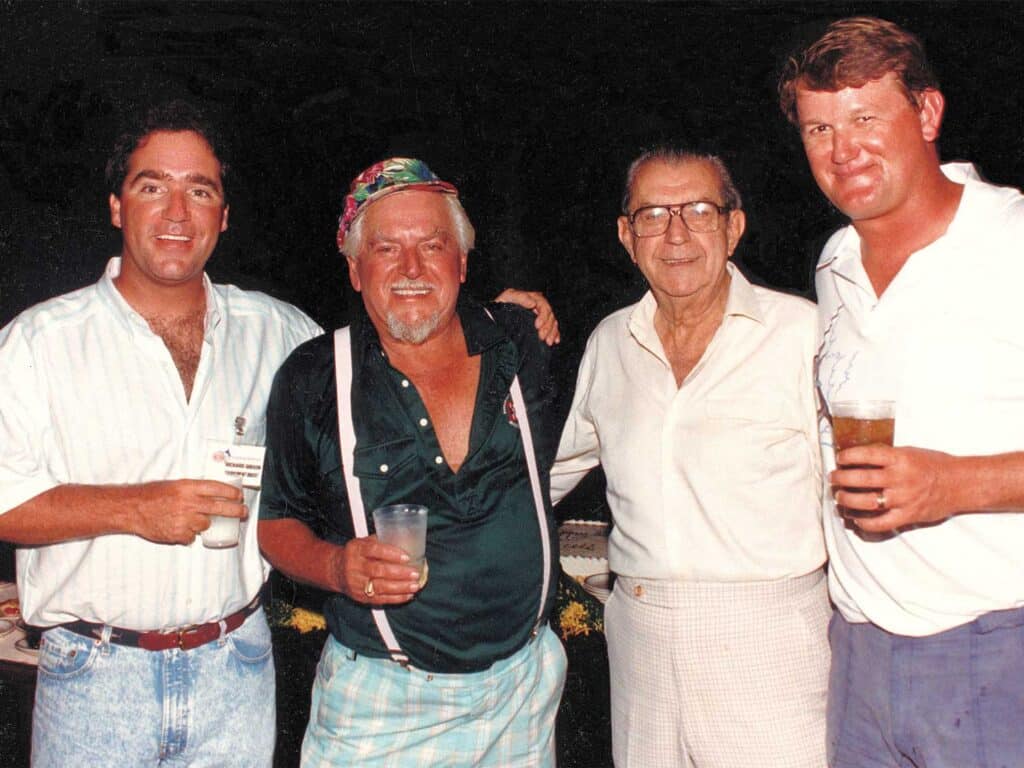 An image of four men standing and posing for the camera.