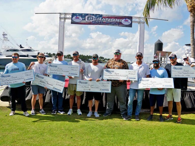 Team Jolene stand at the awards ceremony holding oversized checks.
