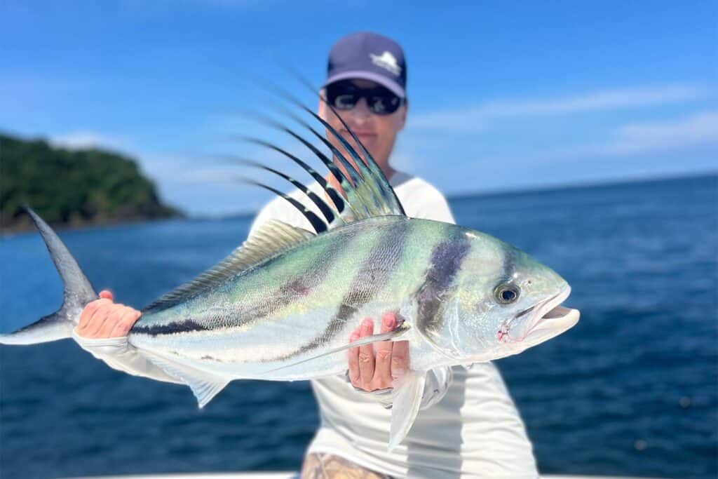 Angler holding tropical fish.