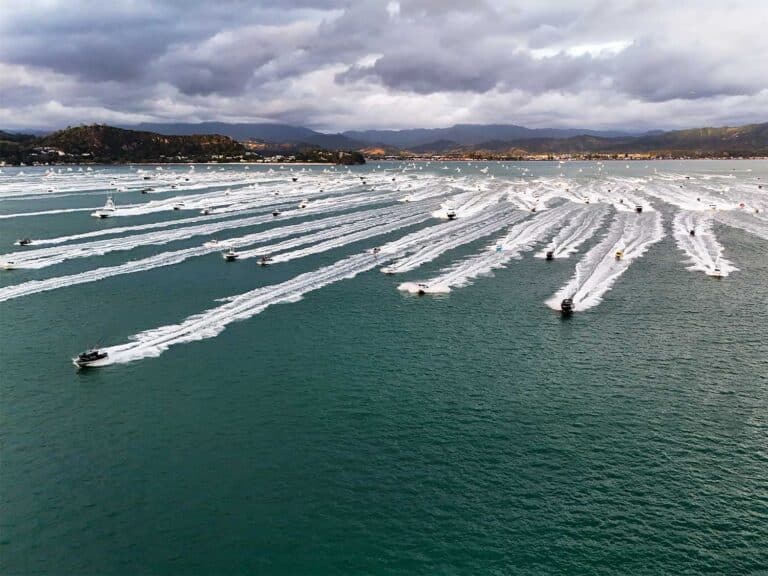A fleet of sport-fishing boats making their way across the water.