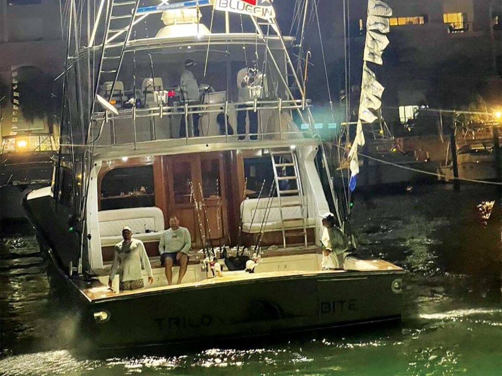 A sport-fishing boat at night.