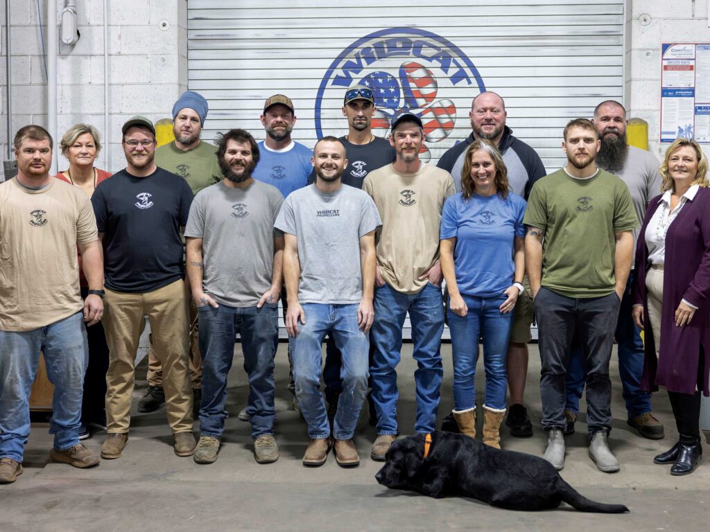 A team of technicians stand in the Wildcat Propeller shop.