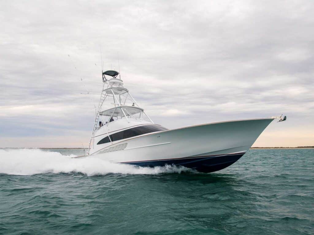A Winter Custom Yacht painted white glides over the water leaving waves in its wake.