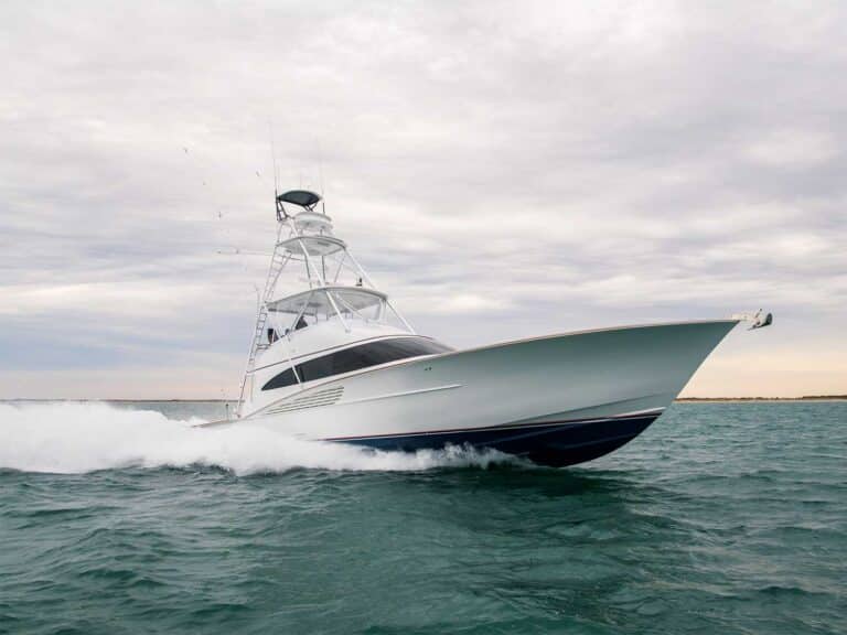 A Winter Custom Yacht painted white glides over the water leaving waves in its wake.