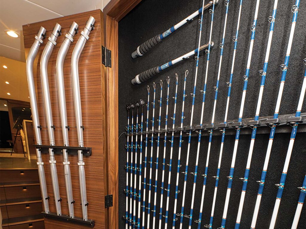 Rod and reel storage found behind a wall panel on the interior of a sport-fishing boat.